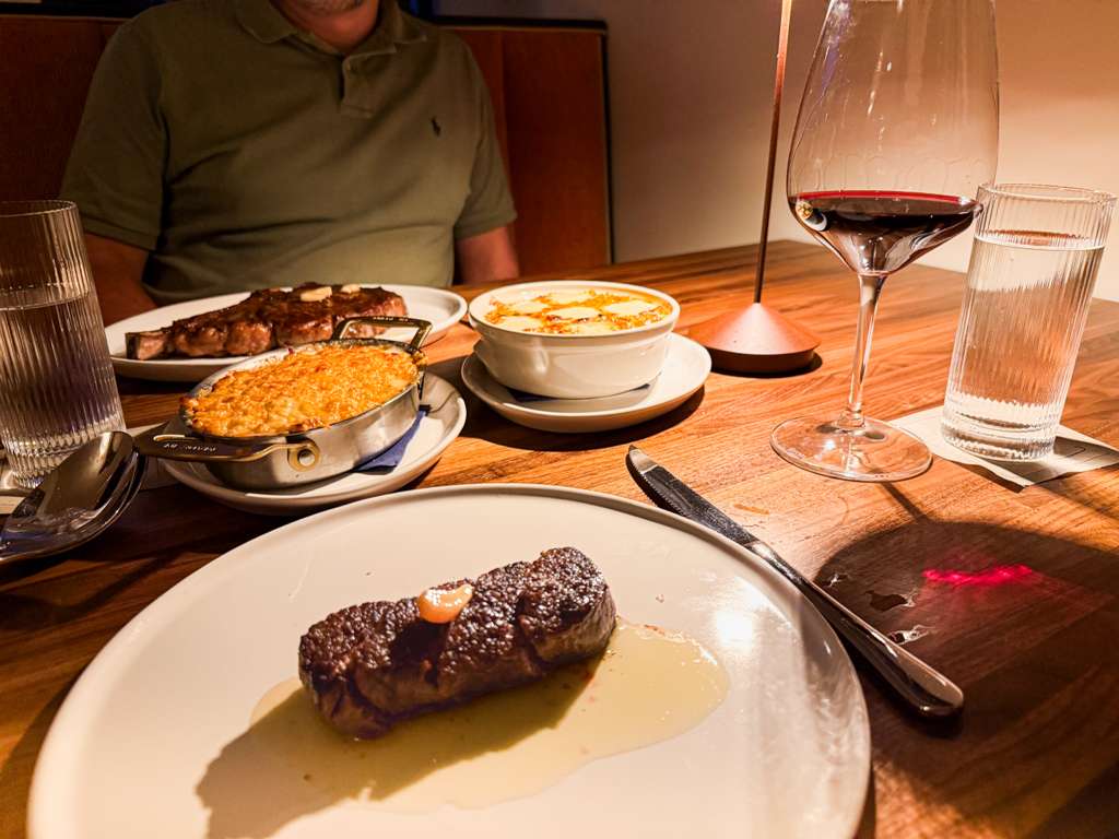 Filet mignon with au gratin potatoes, creamed corn, and red wine at Marbled & Fin, Savannah, Georgia’s newest upscale steakhouse restaurant.